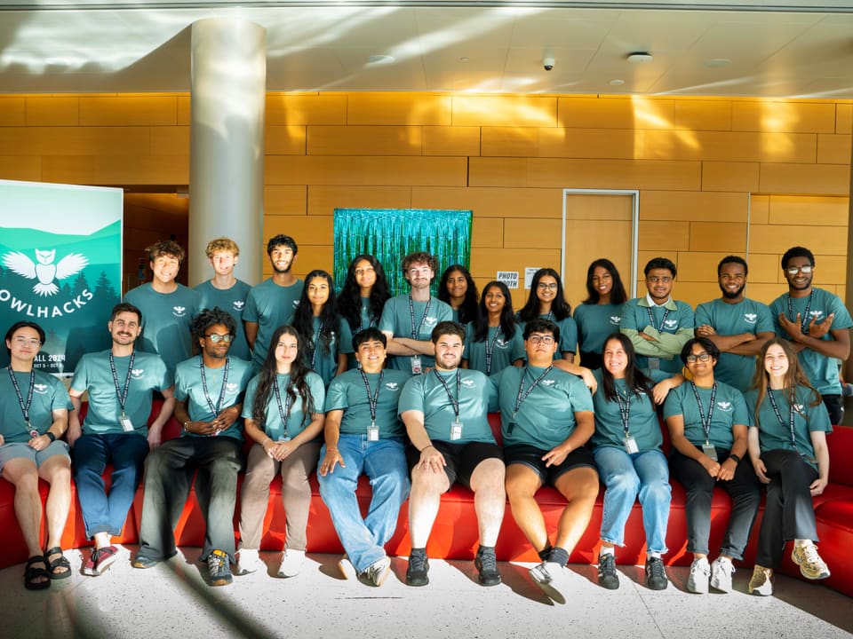 The 2024 OwlHacks organizing committee seated with Faculty Advisor Professor Stephen MacNeil