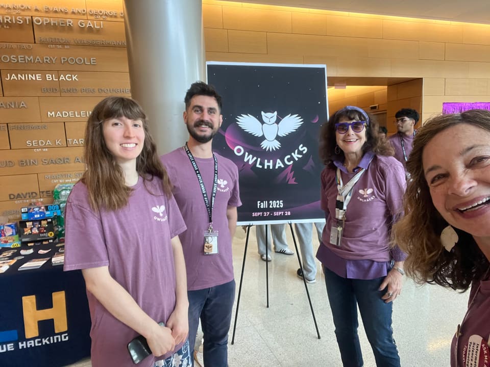 Professor Stephen MacNeil in front of the 2025 OwlHacks poster
