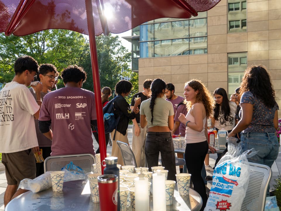 Hackathon attendees networking on the terrace