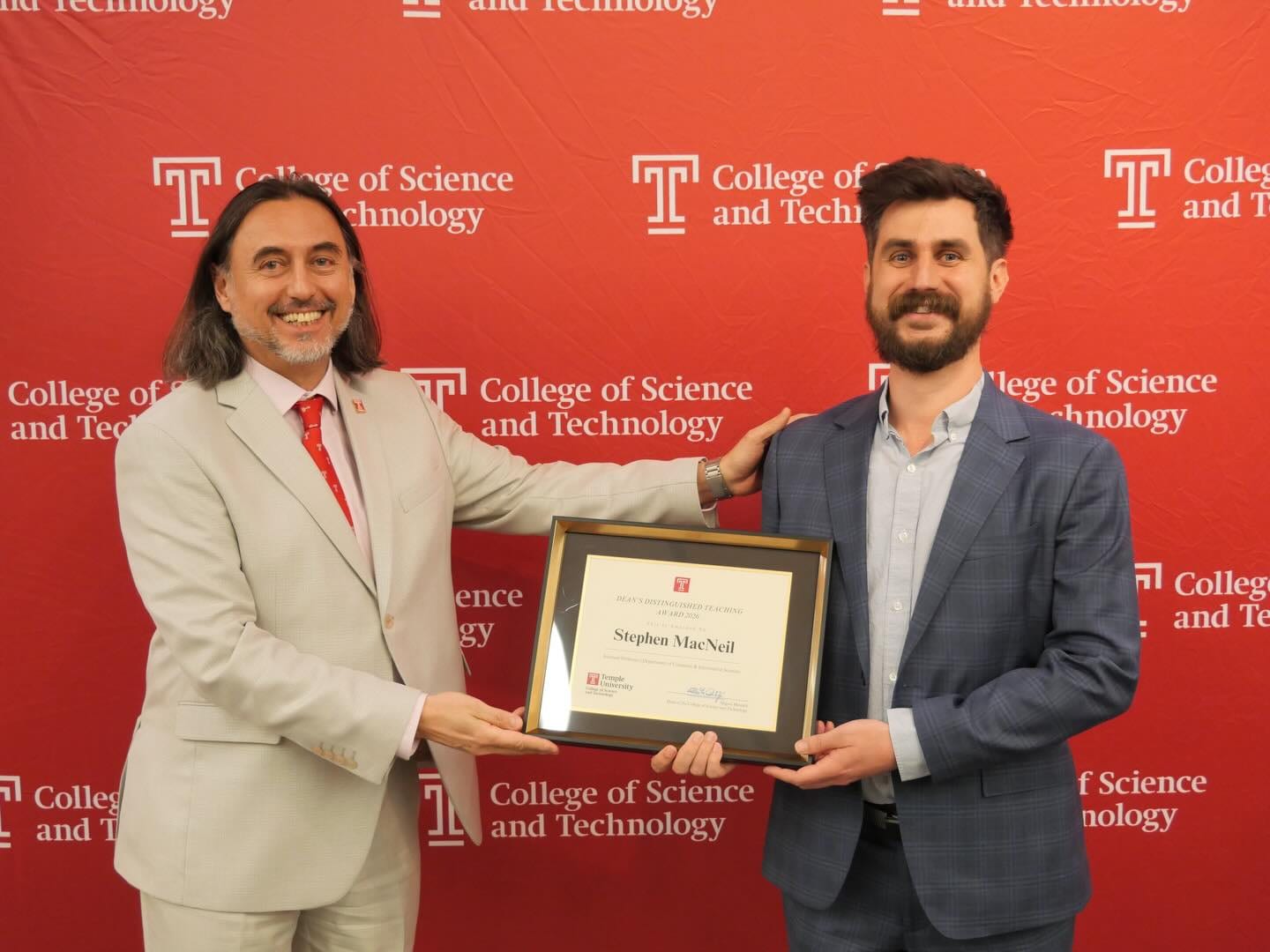 Stephen MacNeil with Dean Miguel Mostafa while holding the teaching award plaque.