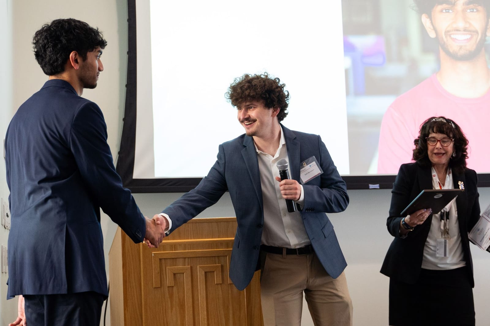 Seth Bernstein presenting a service award to fellow lab member Noel Chacko.