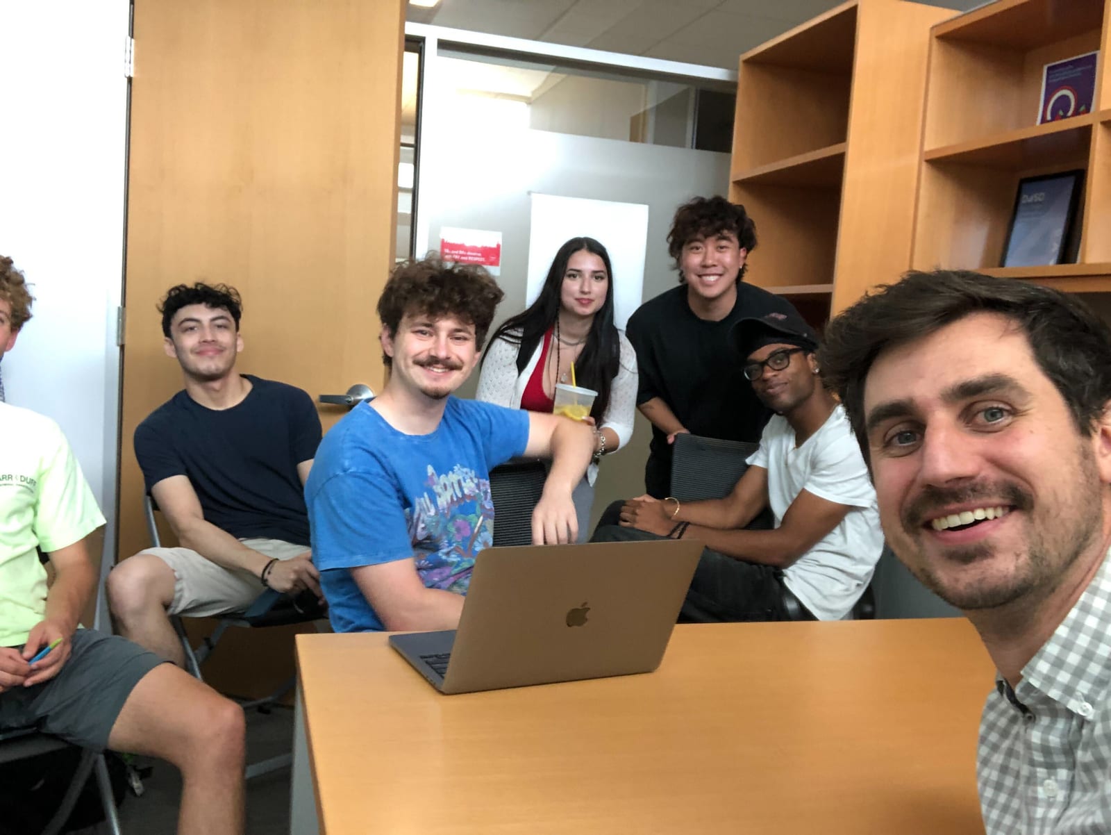 Seth Bernstein meeting with Stephen MacNeil and his research teammates in an office.