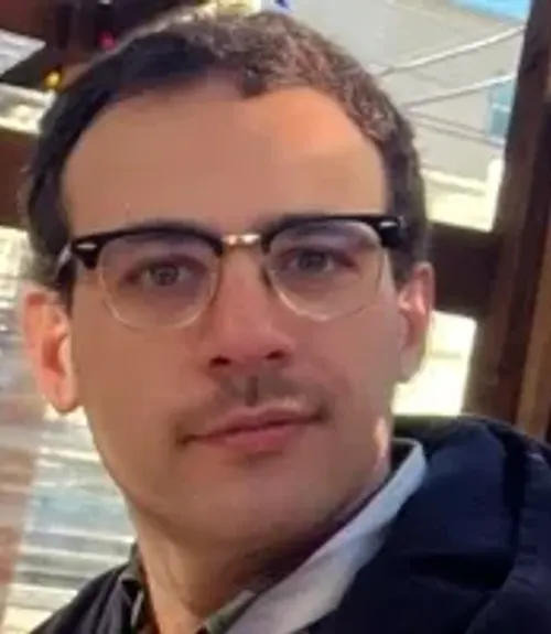 A headshot-style photograph of Ben Smolin