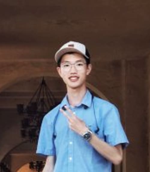 A headshot-style photograph of Fred Huang