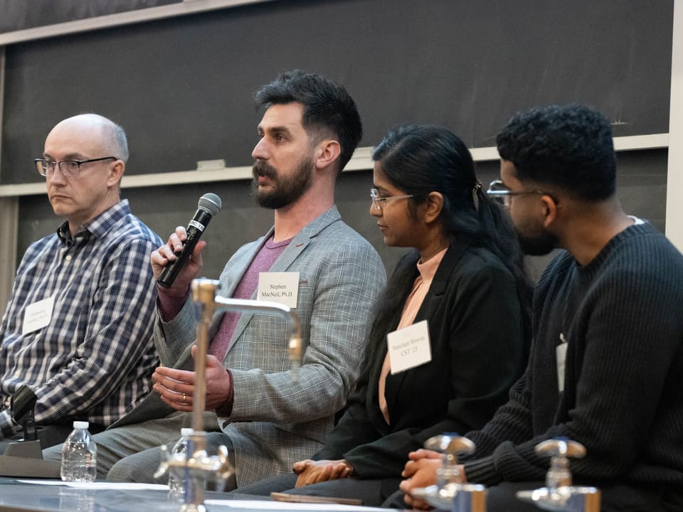 With fellow speakers during a panel event.