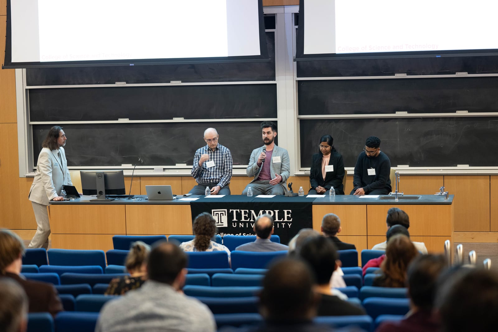 Professor Stephen MacNeil answering audience questions during a Temple University AI panel.