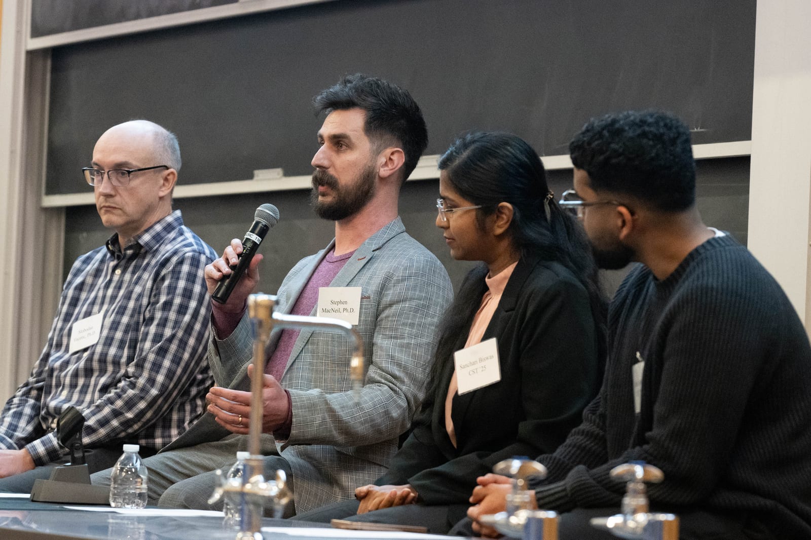 Professor Stephen MacNeil with fellow speakers during a Temple University panel event.